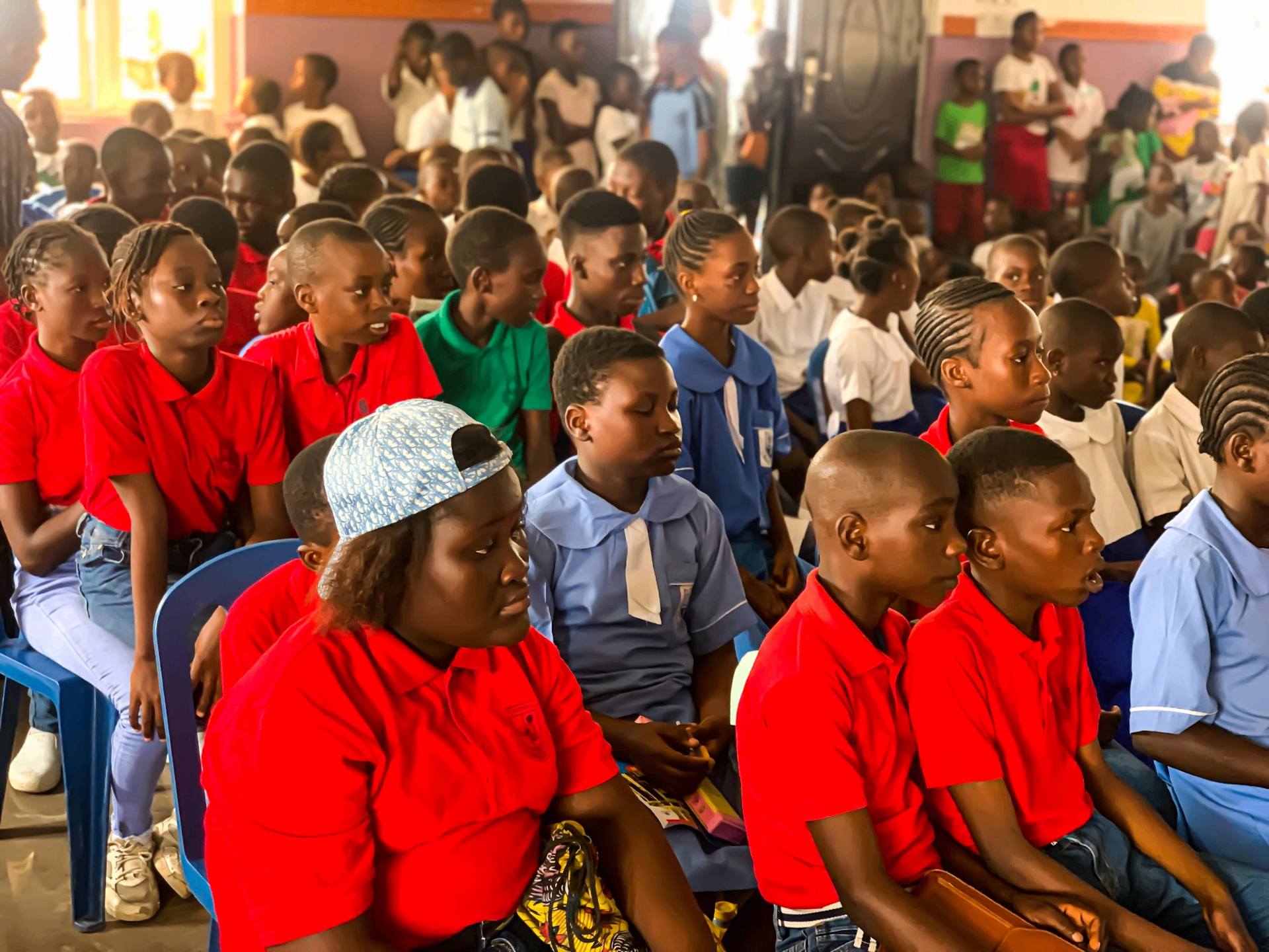 Students seated together during a YVEI school outreach assembly
